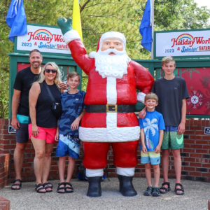 HoliBlogger Trina with her family and the Santa Statue.