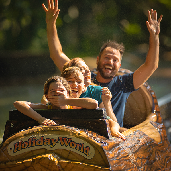 A family laughing after splashing down on Frightful Falls