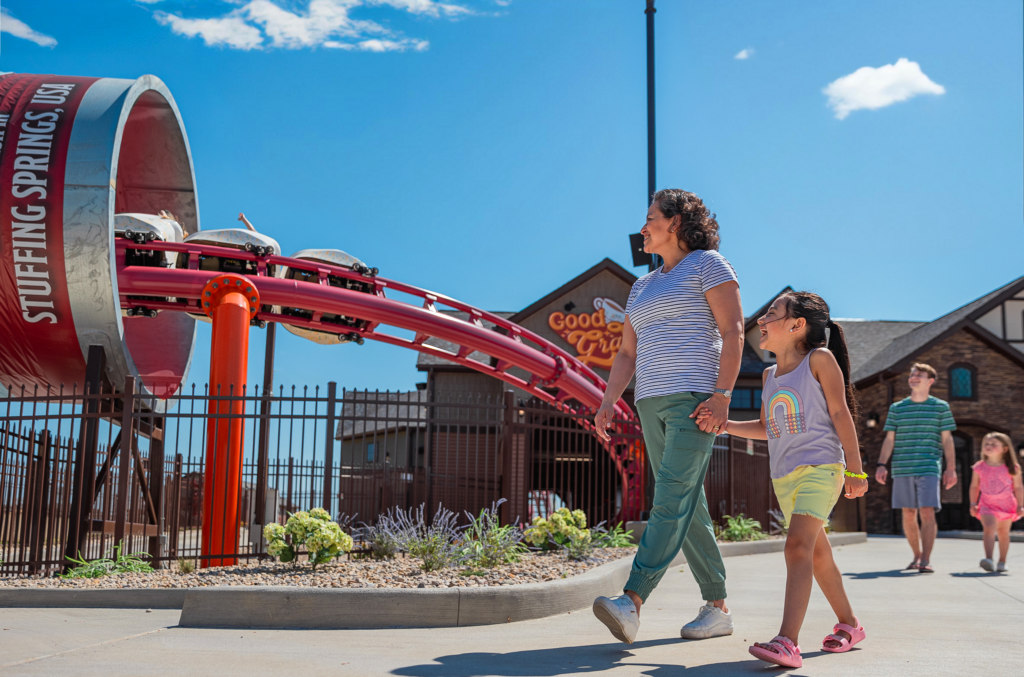 A family walks near the Good Gravy! family coaster