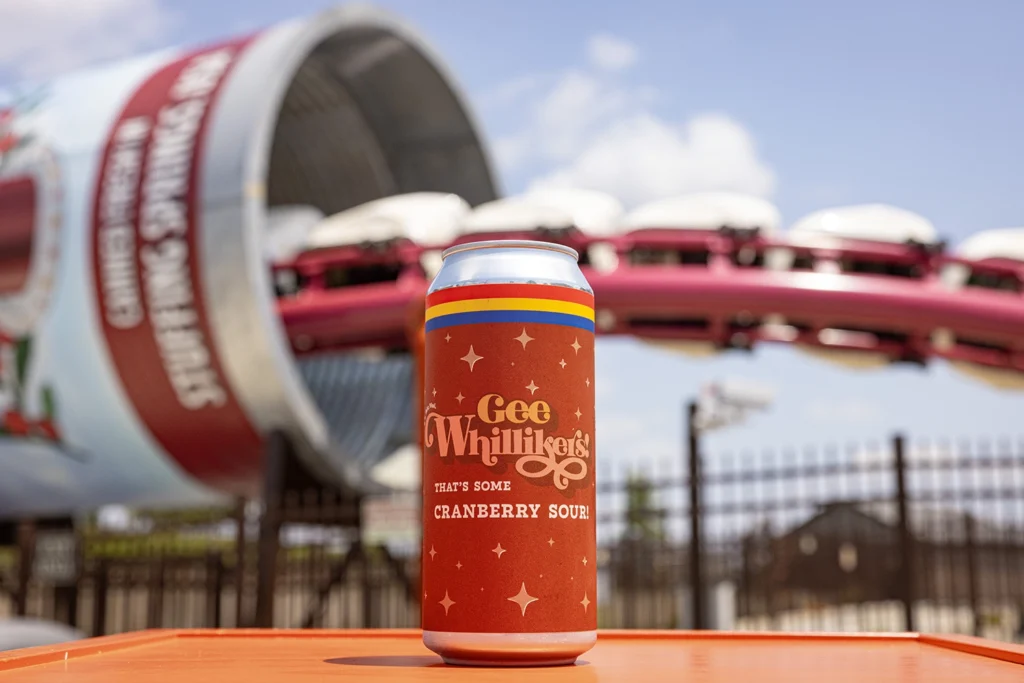 A can of custom-brewed Gee Whillikers Cranberry Sour in front of Good Gravy! Family Coaster.