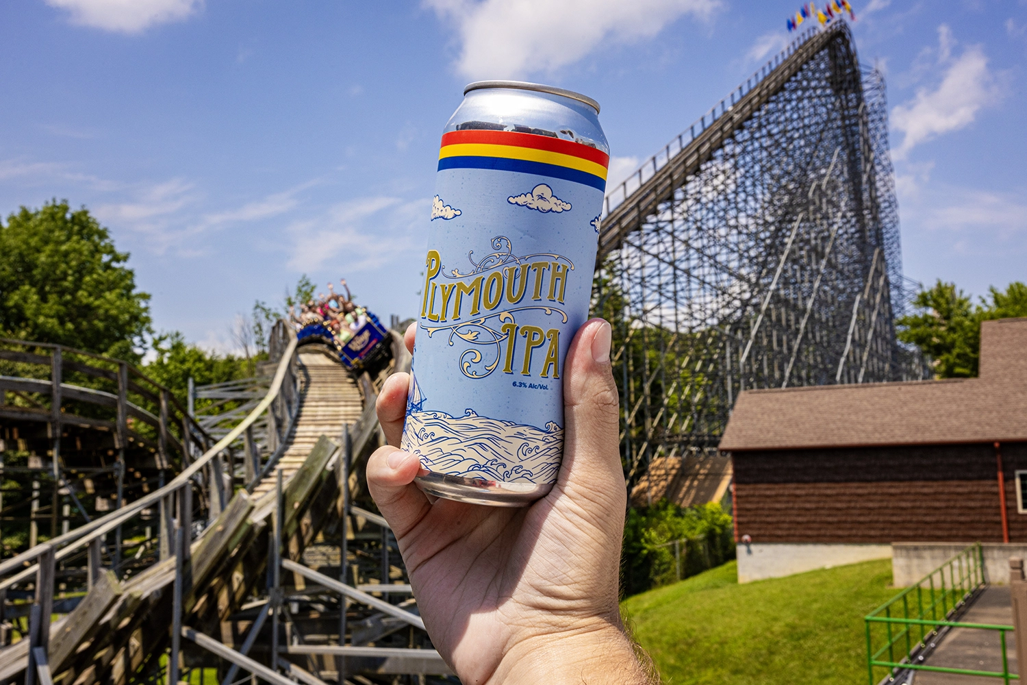 A can of custom-brewed Plymouth IPA in front of The Voyage's lift hill.