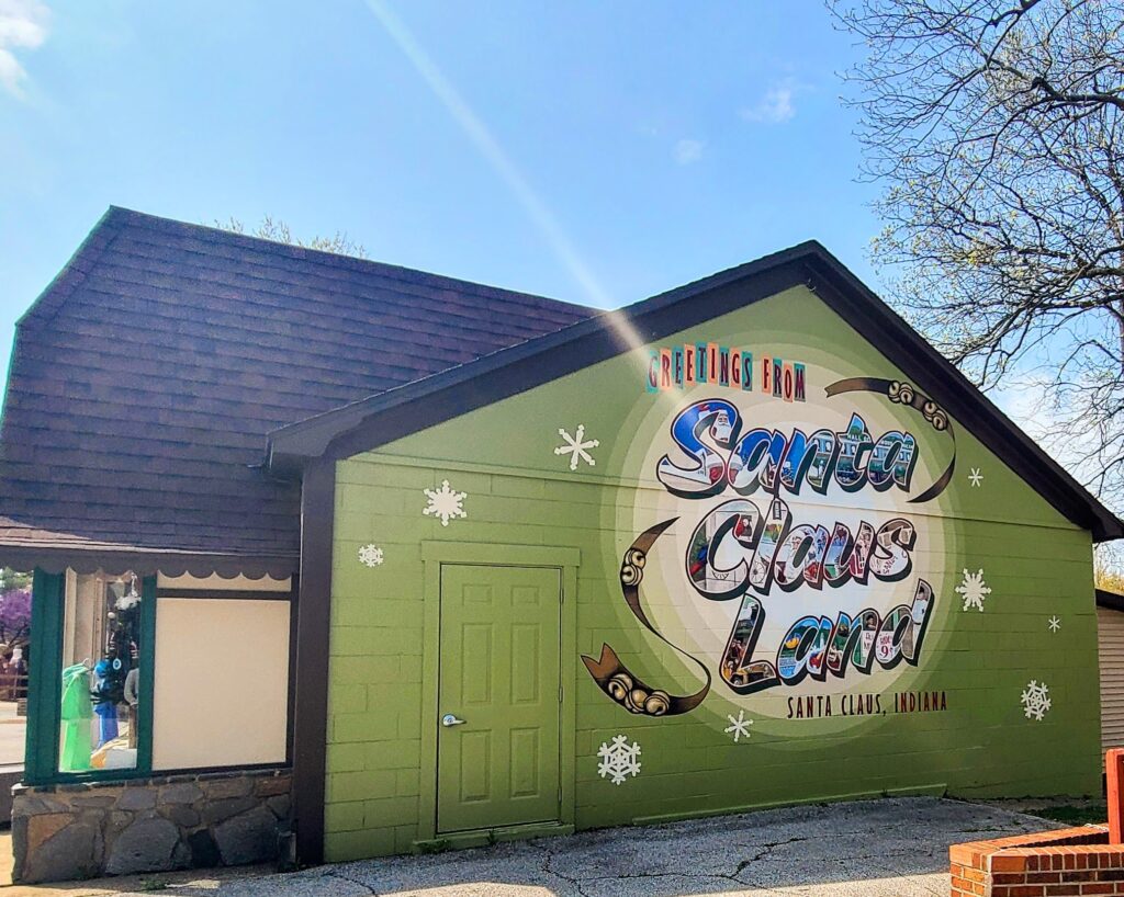 Mural that reads "Santa Claus Land" with images from the parks' history embedded in the letters