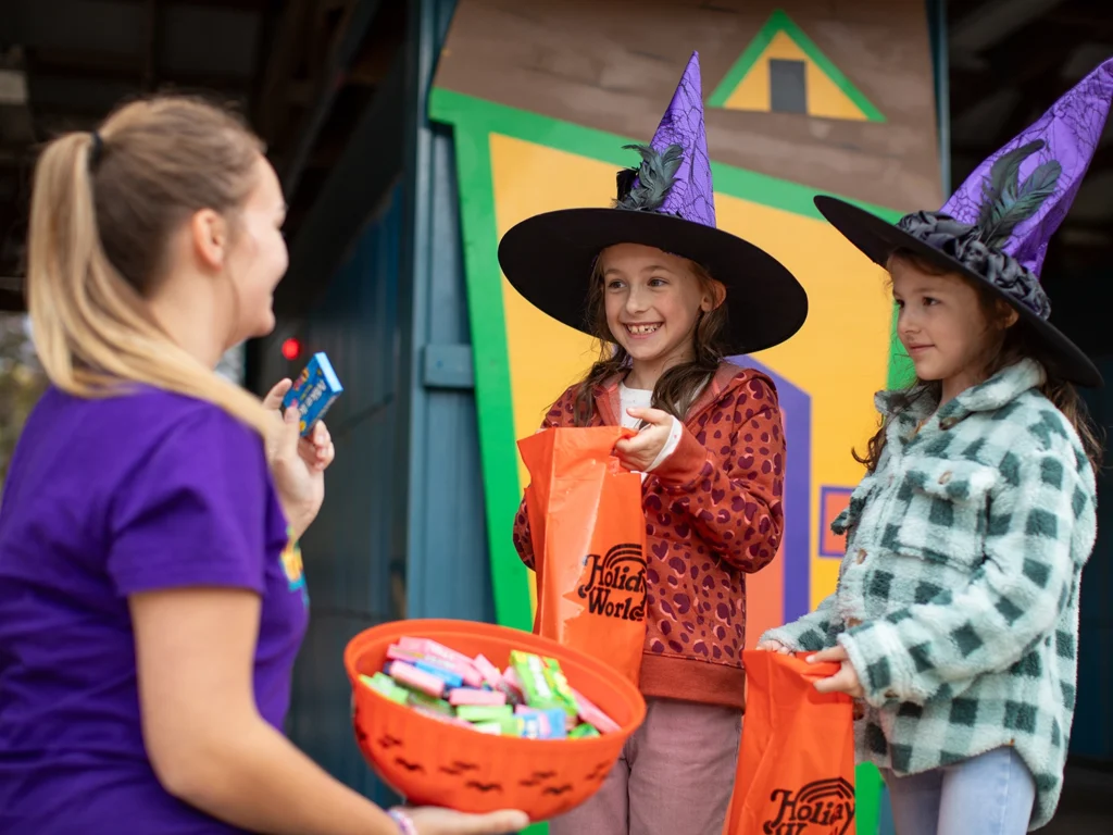 Children receiving candy during the Trick or Treat Trail at Holiday World during Happy Halloween Weekends.