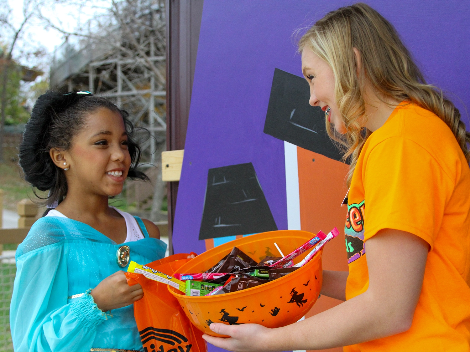 A child receiving candy during the Trick or Treat Trail at Holiday World during Happy Halloween Weekends.