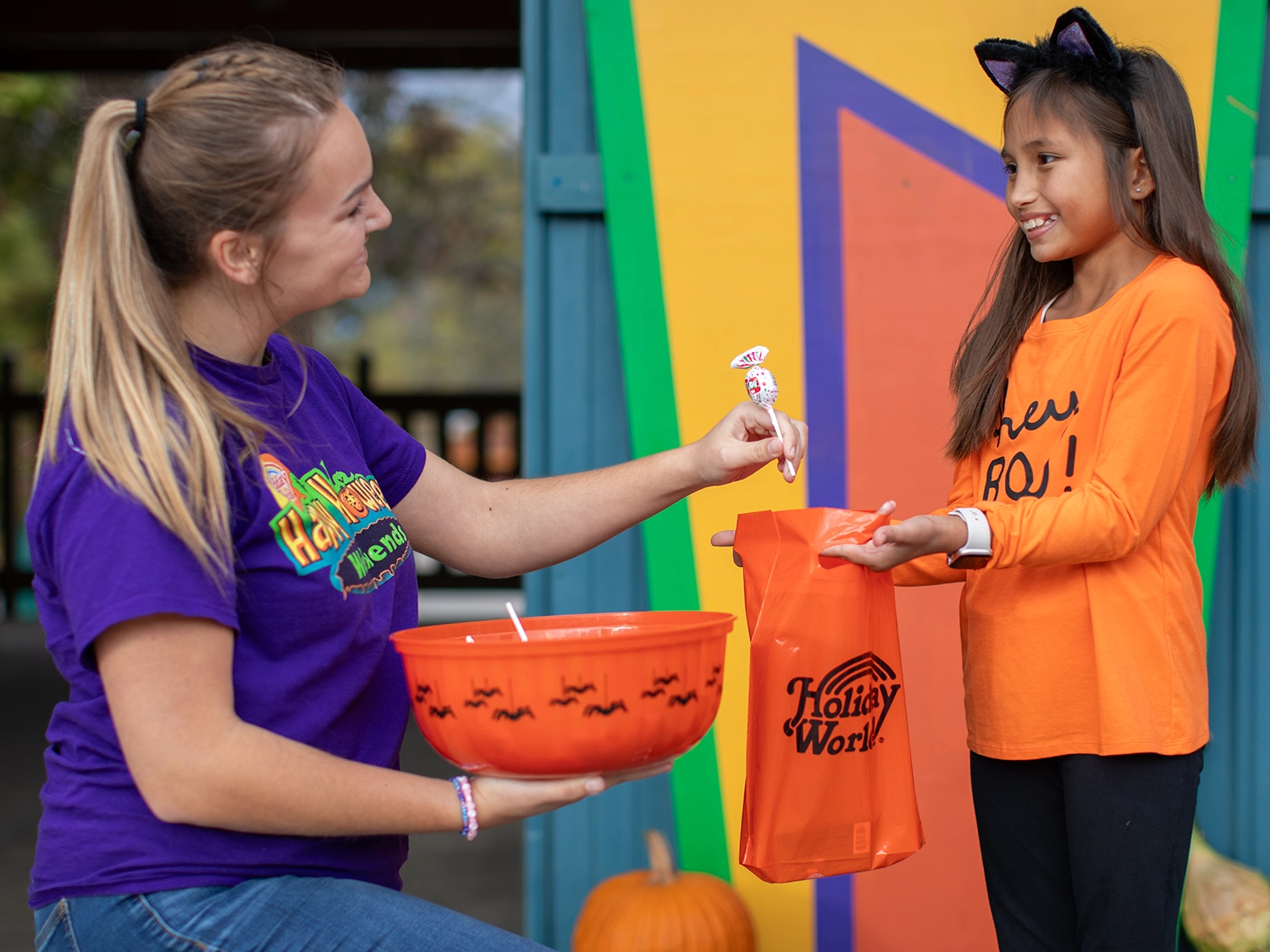 A child receiving candy during the Trick or Treat Trail at Holiday World during Happy Halloween Weekends.