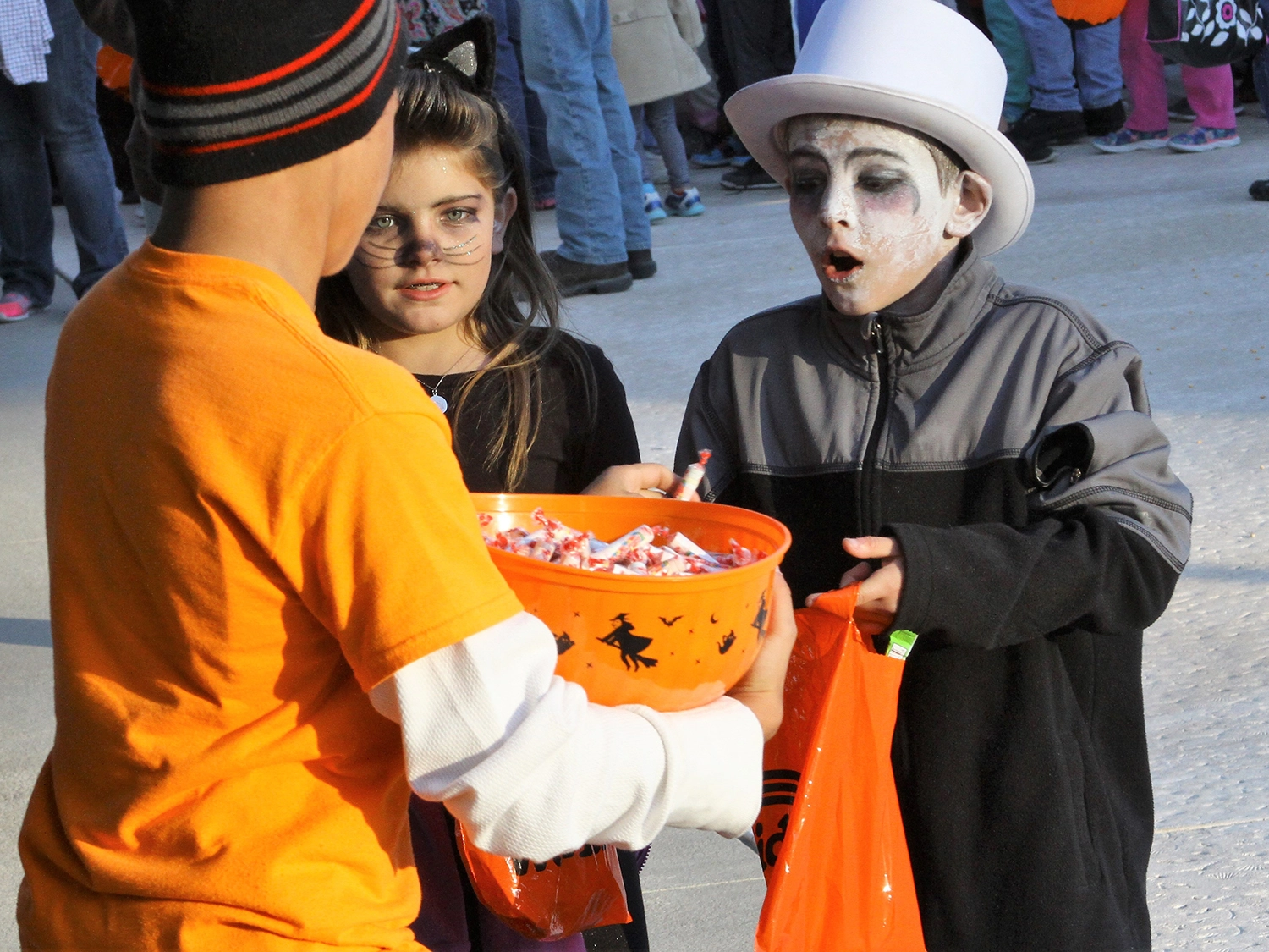 Children receiving candy during the Trick or Treat Trail at Holiday World during Happy Halloween Weekends.