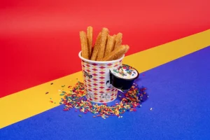 80th Birthday Candles of mini churros with a side of birthday-sprinkled icing