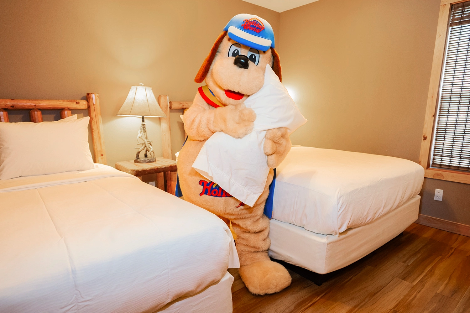 Holidog clutching a pillow inside a cottage at Santa's Cottages